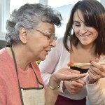 Homecare cooking dinner for elderly woman