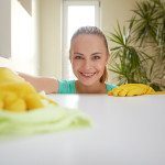 people, housework and housekeeping concept - happy woman cleanin