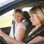 Mature woman with daughter driving car